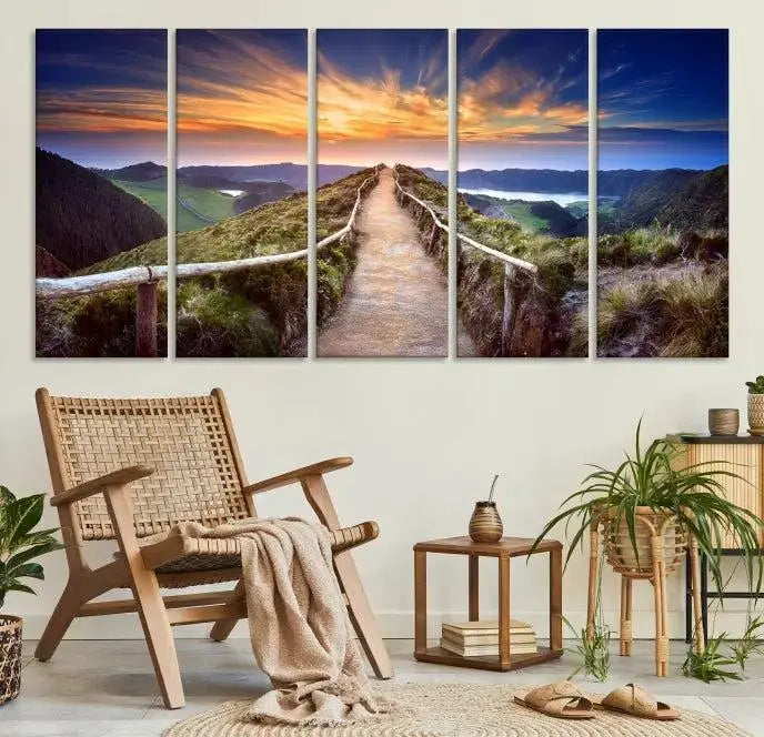 The Mountain and Sunset Wall Art Canvas Print, featuring a three-panel design on museum-quality canvas, captures a stunning sunset over a mountain path with a wooden railing. The hand-assembled frame ensures an exquisite finish and arrives ready to hang, adding natural beauty to any environment.