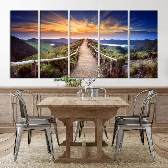 The Mountain and Sunset Wall Art Canvas Print, featuring a three-panel design on museum-quality canvas, captures a stunning sunset over a mountain path with a wooden railing. The hand-assembled frame ensures an exquisite finish and arrives ready to hang, adding natural beauty to any environment.