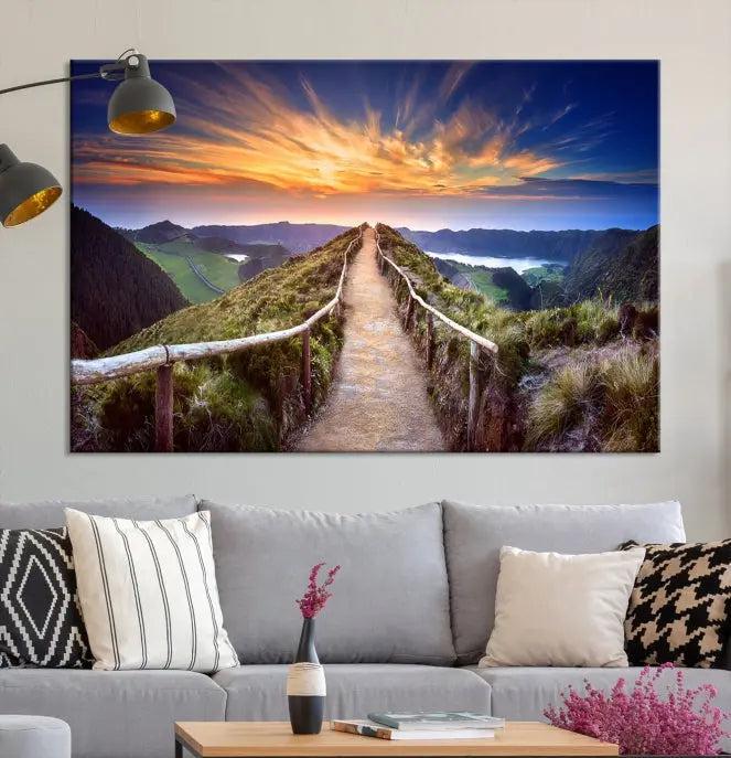 The Mountain and Sunset Wall Art Canvas Print, featuring a three-panel design on museum-quality canvas, captures a stunning sunset over a mountain path with a wooden railing. The hand-assembled frame ensures an exquisite finish and arrives ready to hang, adding natural beauty to any environment.