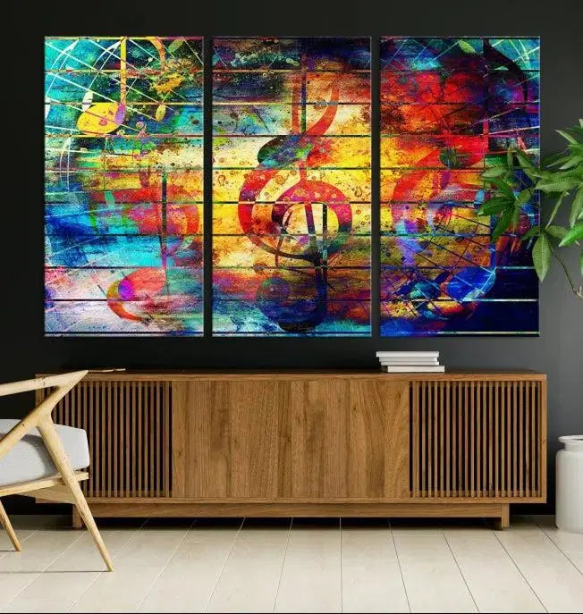 The Music Left Switch Abstract Wall Art Canvas Print features three panels of vibrant colors and music notes. Crafted on museum-quality canvases with a UV-protective coating, it offers lasting elegance.