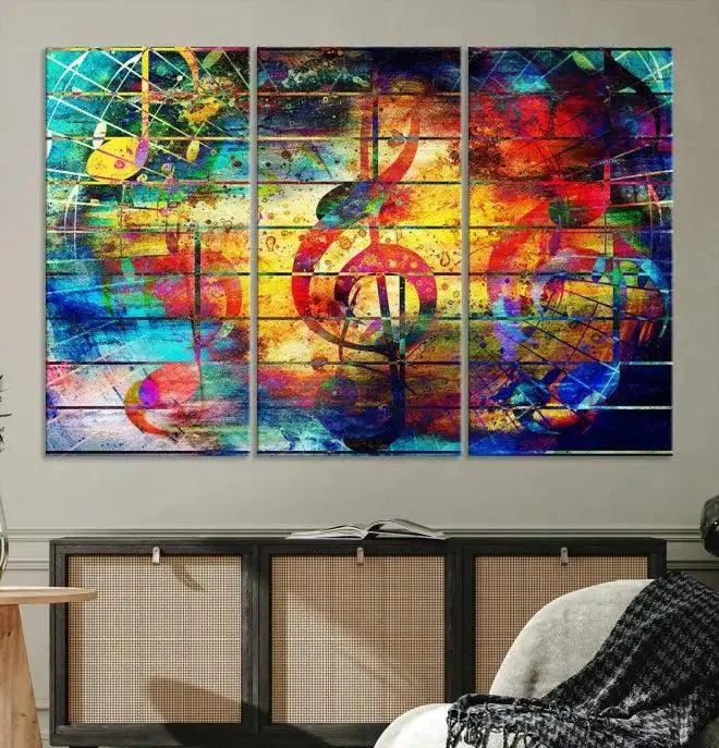 The Music Left Switch Abstract Wall Art Canvas Print features three panels of vibrant colors and music notes. Crafted on museum-quality canvases with a UV-protective coating, it offers lasting elegance.