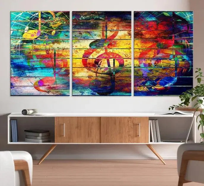 The Music Left Switch Abstract Wall Art Canvas Print features three panels of vibrant colors and music notes. Crafted on museum-quality canvases with a UV-protective coating, it offers lasting elegance.