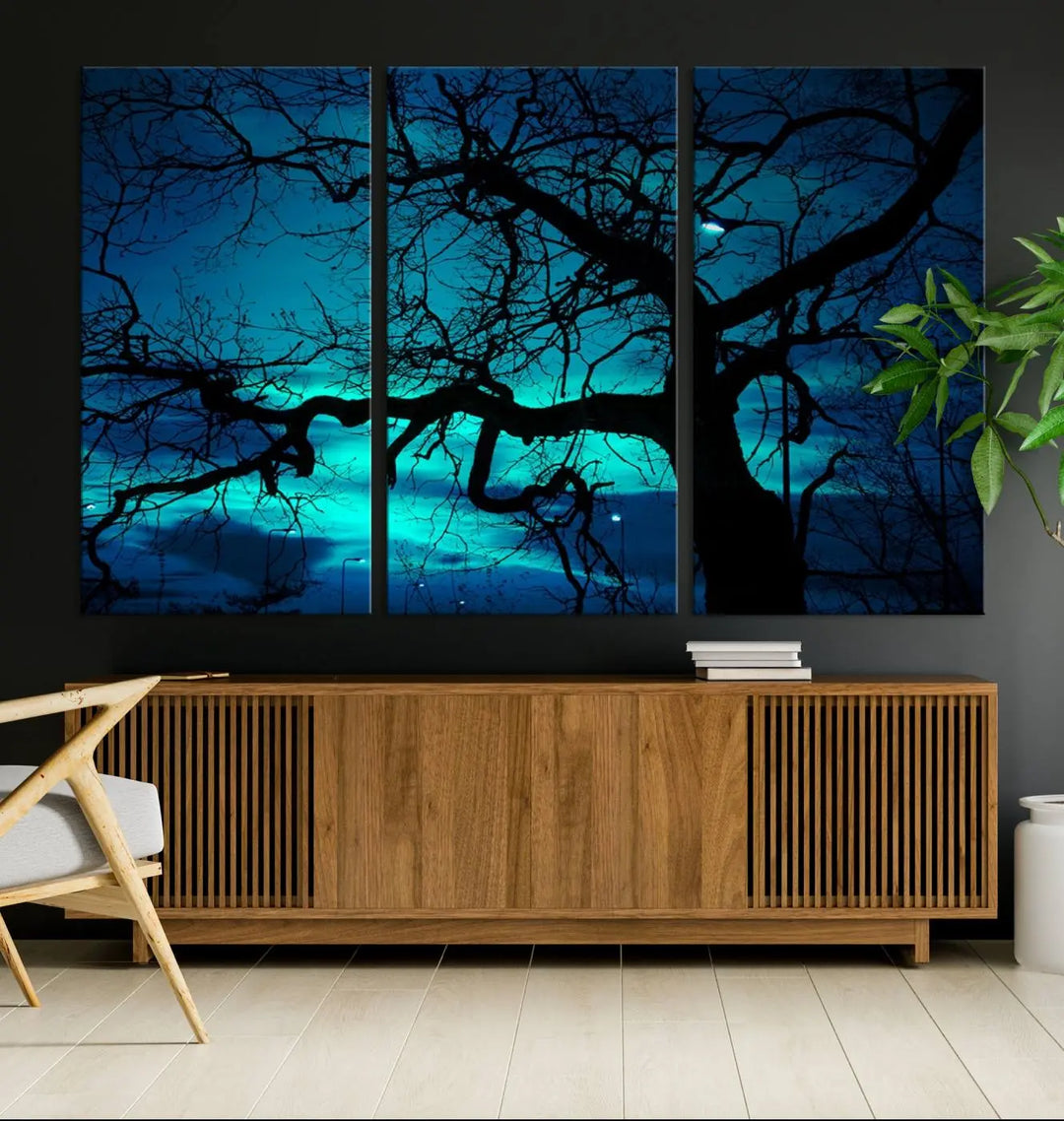 The Mystic Dark Forest Tree Wall Art Canvas Print showcases a tree silhouette set against a teal sky. Crafted on museum-quality canvas and gallery wrapped, it includes a UV-protective coating for lasting vibrancy.