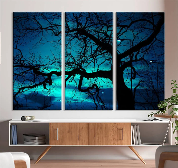 The Mystic Dark Forest Tree Wall Art Canvas Print showcases a tree silhouette set against a teal sky. Crafted on museum-quality canvas and gallery wrapped, it includes a UV-protective coating for lasting vibrancy.