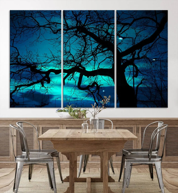 The Mystic Dark Forest Tree Wall Art Canvas Print showcases a tree silhouette set against a teal sky. Crafted on museum-quality canvas and gallery wrapped, it includes a UV-protective coating for lasting vibrancy.