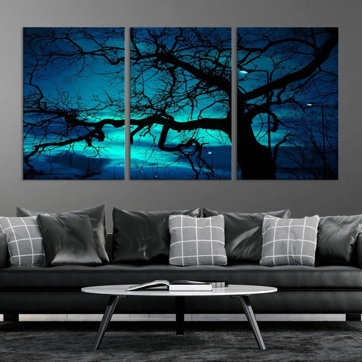 The Mystic Dark Forest Tree Wall Art Canvas Print showcases a tree silhouette set against a teal sky. Crafted on museum-quality canvas and gallery wrapped, it includes a UV-protective coating for lasting vibrancy.