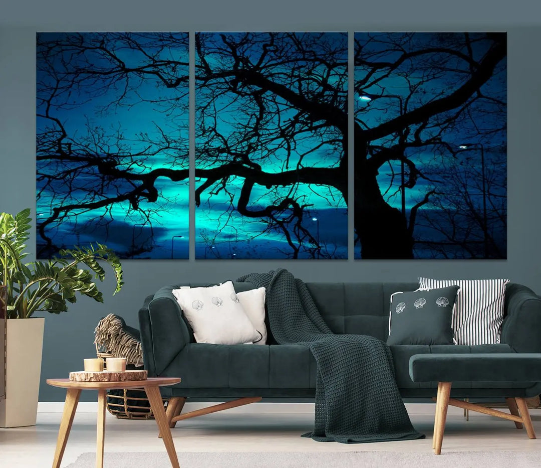 The Mystic Dark Forest Tree Wall Art Canvas Print showcases a tree silhouette set against a teal sky. Crafted on museum-quality canvas and gallery wrapped, it includes a UV-protective coating for lasting vibrancy.