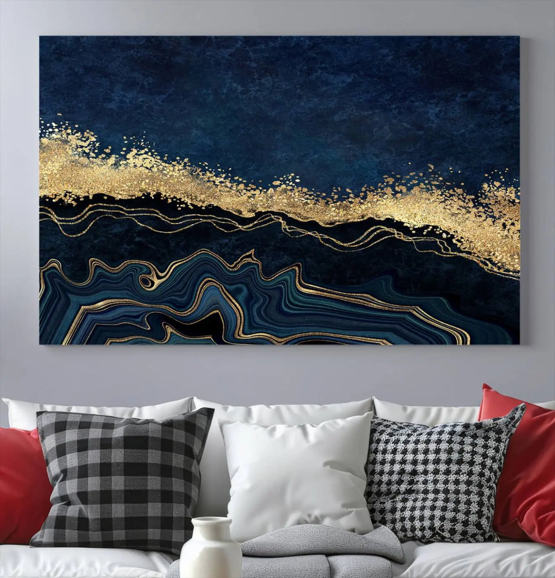 A modern living room featuring a ready-to-hang Navy Blue Marble Fluid Effect Large Wall Art, a stunning abstract triptych on museum-quality canvas in blue and gold. The artwork's vibrant colors are preserved with an enhanced UV-protective coating.