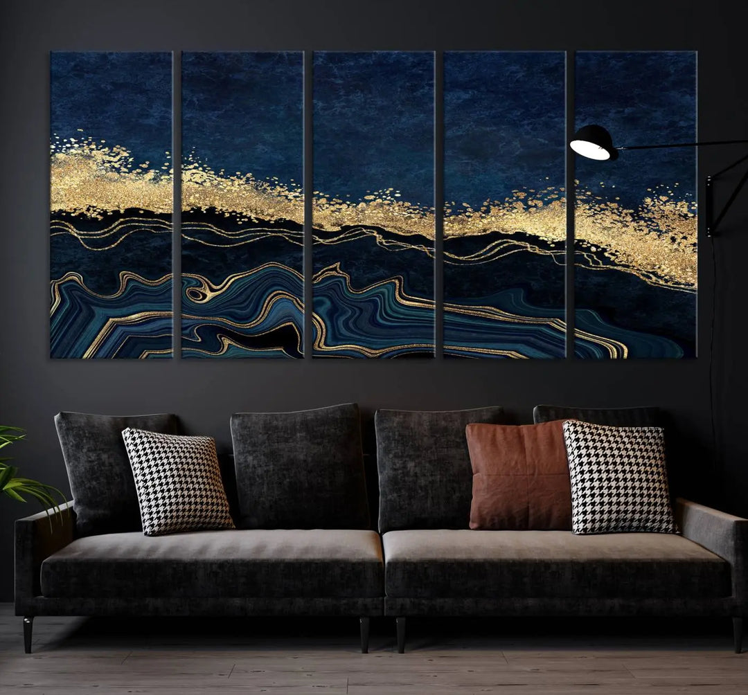 A modern living room featuring a ready-to-hang Navy Blue Marble Fluid Effect Large Wall Art, a stunning abstract triptych on museum-quality canvas in blue and gold. The artwork's vibrant colors are preserved with an enhanced UV-protective coating.