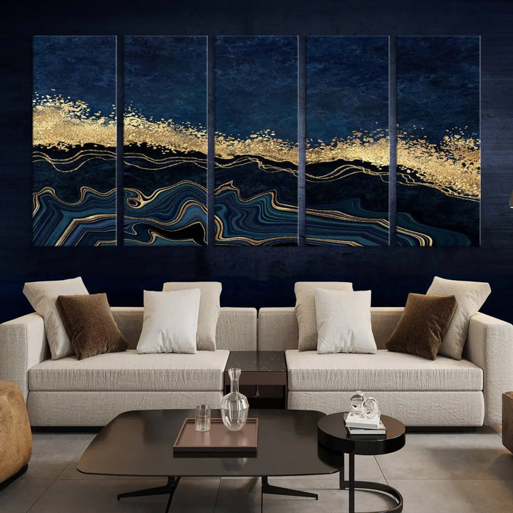 A modern living room featuring a ready-to-hang Navy Blue Marble Fluid Effect Large Wall Art, a stunning abstract triptych on museum-quality canvas in blue and gold. The artwork's vibrant colors are preserved with an enhanced UV-protective coating.