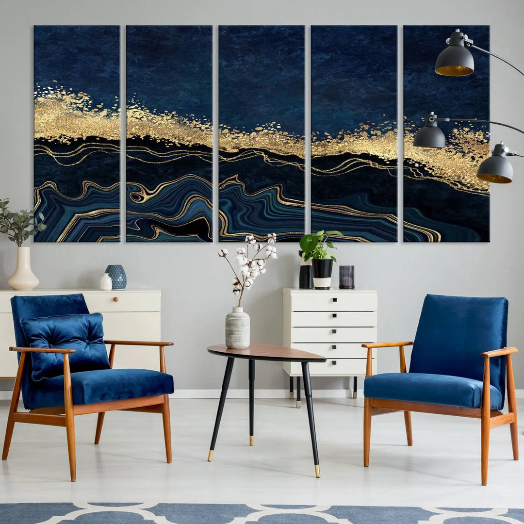 A modern living room featuring a ready-to-hang Navy Blue Marble Fluid Effect Large Wall Art, a stunning abstract triptych on museum-quality canvas in blue and gold. The artwork's vibrant colors are preserved with an enhanced UV-protective coating.