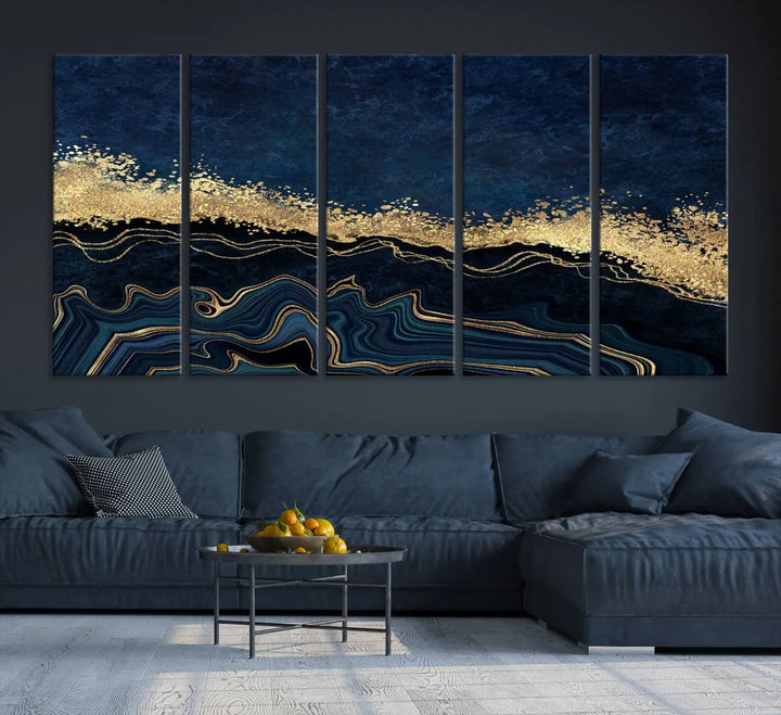 A modern living room featuring a ready-to-hang Navy Blue Marble Fluid Effect Large Wall Art, a stunning abstract triptych on museum-quality canvas in blue and gold. The artwork's vibrant colors are preserved with an enhanced UV-protective coating.