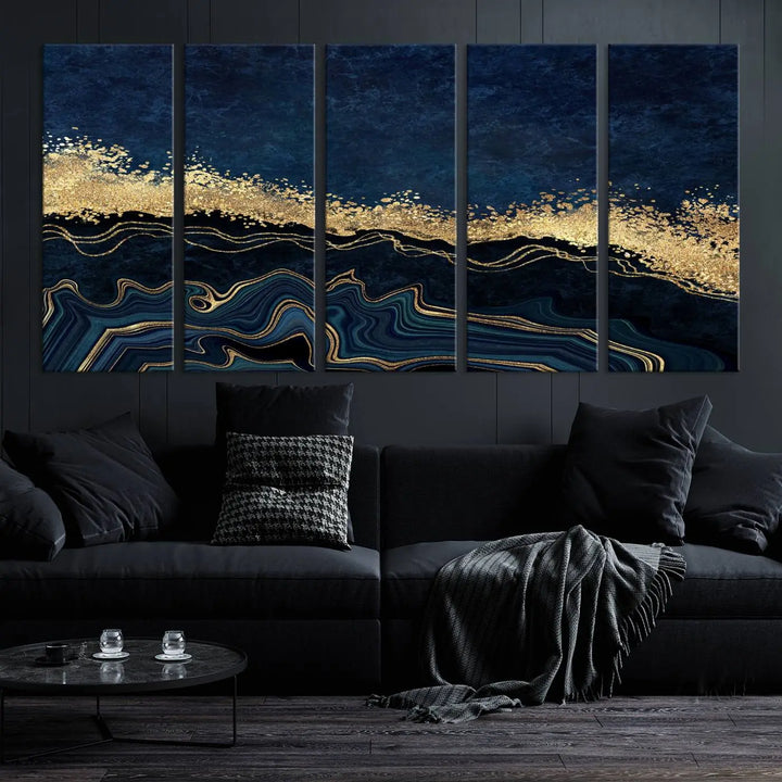 A modern living room featuring a ready-to-hang Navy Blue Marble Fluid Effect Large Wall Art, a stunning abstract triptych on museum-quality canvas in blue and gold. The artwork's vibrant colors are preserved with an enhanced UV-protective coating.