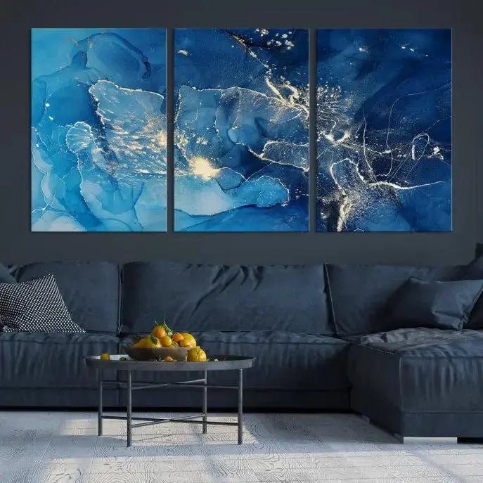 A modern living room features the "Navy Blue Marble Fluid Effect Wall Art Abstract Canvas Wall Art Print" above a white sofa. The museum-quality canvas adds an effortless touch of elegance.