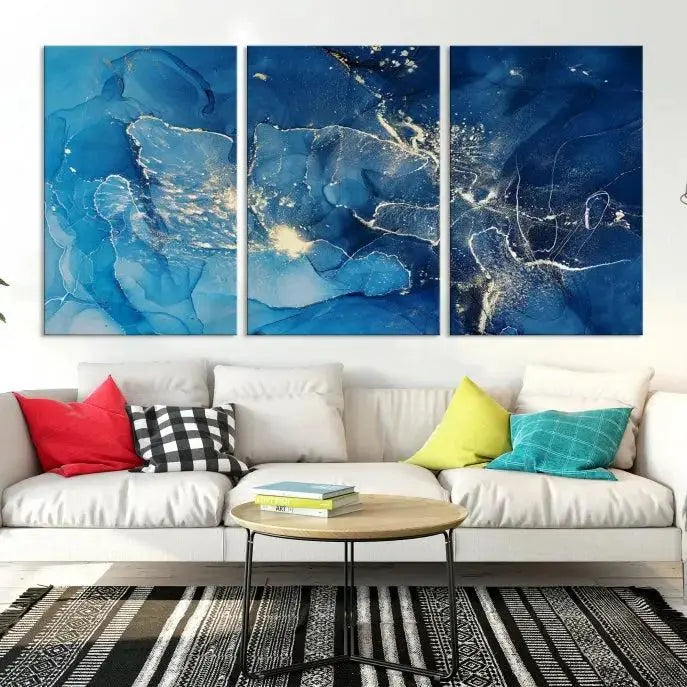 A modern living room features the "Navy Blue Marble Fluid Effect Wall Art Abstract Canvas Wall Art Print" above a white sofa. The museum-quality canvas adds an effortless touch of elegance.