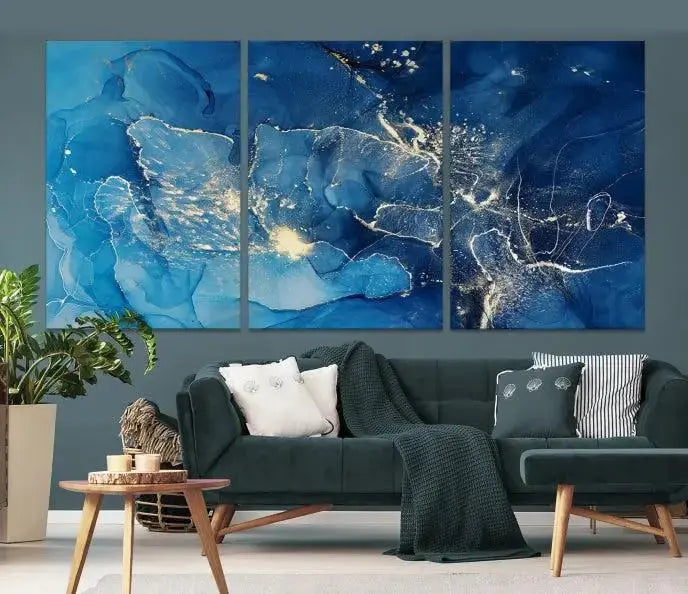 A modern living room features the "Navy Blue Marble Fluid Effect Wall Art Abstract Canvas Wall Art Print" above a white sofa. The museum-quality canvas adds an effortless touch of elegance.