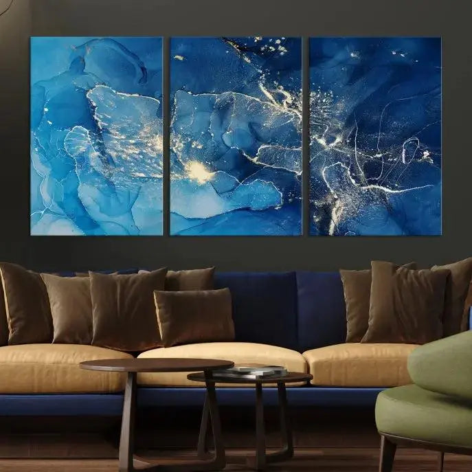 A modern living room features the "Navy Blue Marble Fluid Effect Wall Art Abstract Canvas Wall Art Print" above a white sofa. The museum-quality canvas adds an effortless touch of elegance.