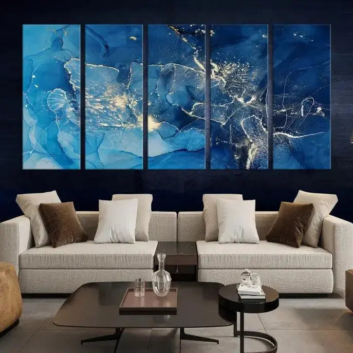 A modern living room features the "Navy Blue Marble Fluid Effect Wall Art Abstract Canvas Wall Art Print" above a white sofa. The museum-quality canvas adds an effortless touch of elegance.