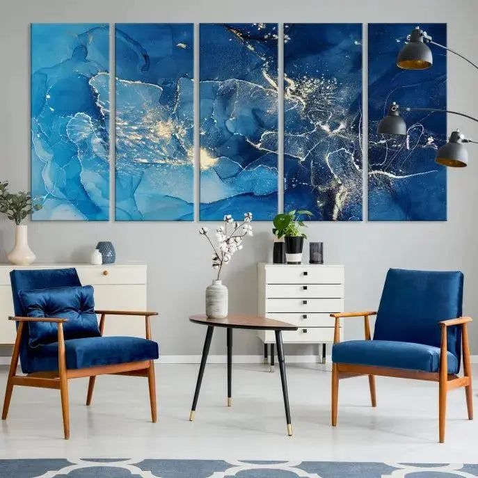 A modern living room features the "Navy Blue Marble Fluid Effect Wall Art Abstract Canvas Wall Art Print" above a white sofa. The museum-quality canvas adds an effortless touch of elegance.