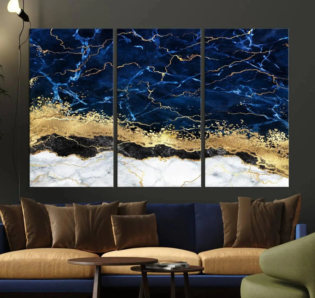 The living room is adorned with the Navy Blue Marble Fluid Effect Wall Art Abstract Canvas Wall Art Print. This ready-to-hang three-panel artwork features blue, gold, and white tones on museum-quality canvas with a UV-protective coating.