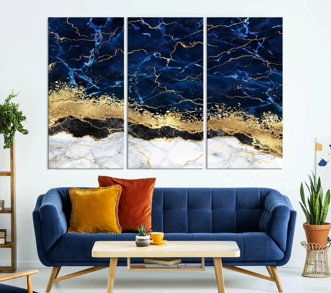 The living room is adorned with the Navy Blue Marble Fluid Effect Wall Art Abstract Canvas Wall Art Print. This ready-to-hang three-panel artwork features blue, gold, and white tones on museum-quality canvas with a UV-protective coating.