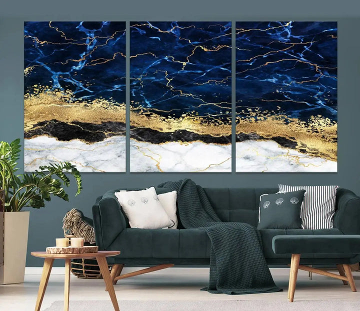 The living room is adorned with the Navy Blue Marble Fluid Effect Wall Art Abstract Canvas Wall Art Print. This ready-to-hang three-panel artwork features blue, gold, and white tones on museum-quality canvas with a UV-protective coating.