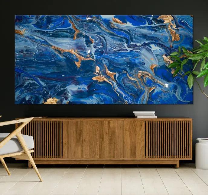 Adorn the space above your couch with the "Navy Blue Marble Fluid Effect Wall Art Abstract Canvas Wall Art Print," featuring exquisite blue and gold swirling patterns on museum-quality canvases.