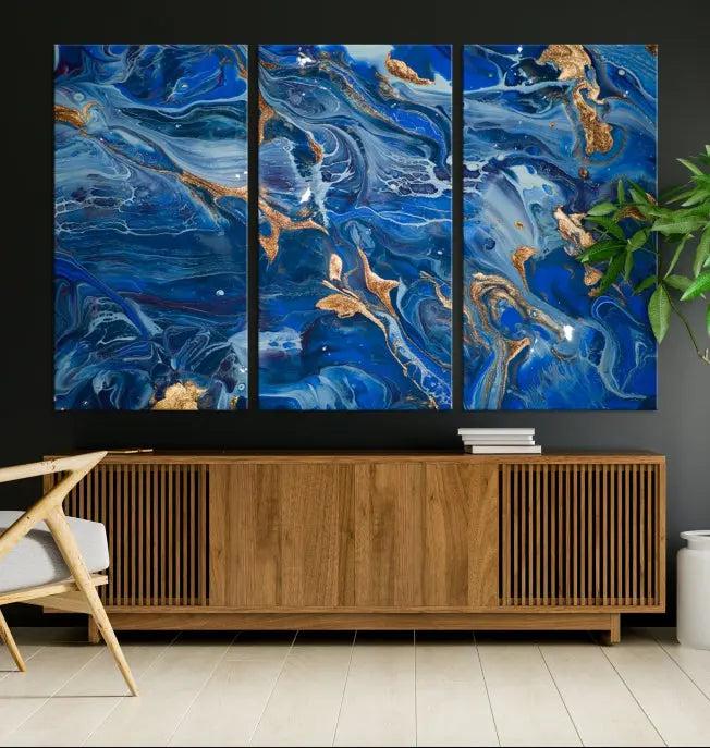 Adorn the space above your couch with the "Navy Blue Marble Fluid Effect Wall Art Abstract Canvas Wall Art Print," featuring exquisite blue and gold swirling patterns on museum-quality canvases.