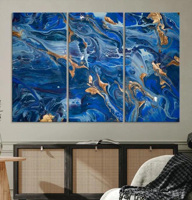 Adorn the space above your couch with the "Navy Blue Marble Fluid Effect Wall Art Abstract Canvas Wall Art Print," featuring exquisite blue and gold swirling patterns on museum-quality canvases.