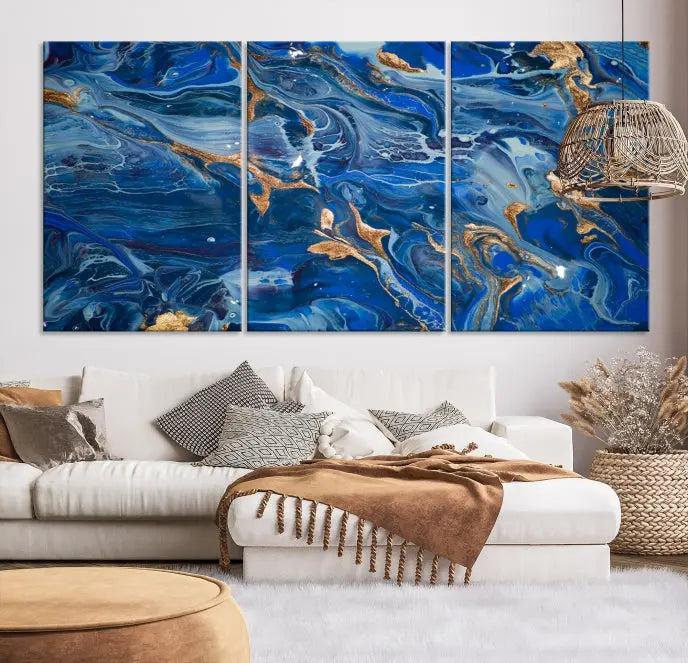 Adorn the space above your couch with the "Navy Blue Marble Fluid Effect Wall Art Abstract Canvas Wall Art Print," featuring exquisite blue and gold swirling patterns on museum-quality canvases.