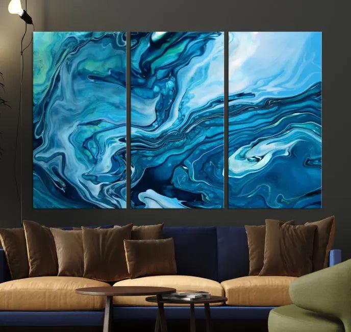 A triptych of the Navy Blue Marble Fluid Effect Wall Art Abstract Canvas Print, featuring swirling blue patterns, graces the space. These pieces are crafted on museum-quality canvas and gallery wrapped with a UV-protective coating to ensure longevity.