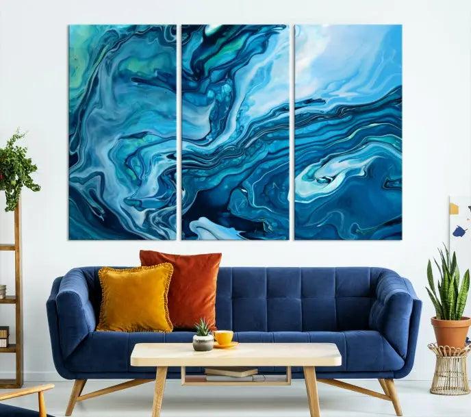 A triptych of the Navy Blue Marble Fluid Effect Wall Art Abstract Canvas Print, featuring swirling blue patterns, graces the space. These pieces are crafted on museum-quality canvas and gallery wrapped with a UV-protective coating to ensure longevity.