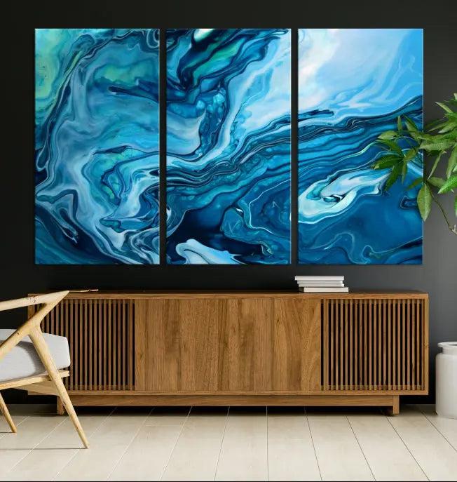 A triptych of the Navy Blue Marble Fluid Effect Wall Art Abstract Canvas Print, featuring swirling blue patterns, graces the space. These pieces are crafted on museum-quality canvas and gallery wrapped with a UV-protective coating to ensure longevity.