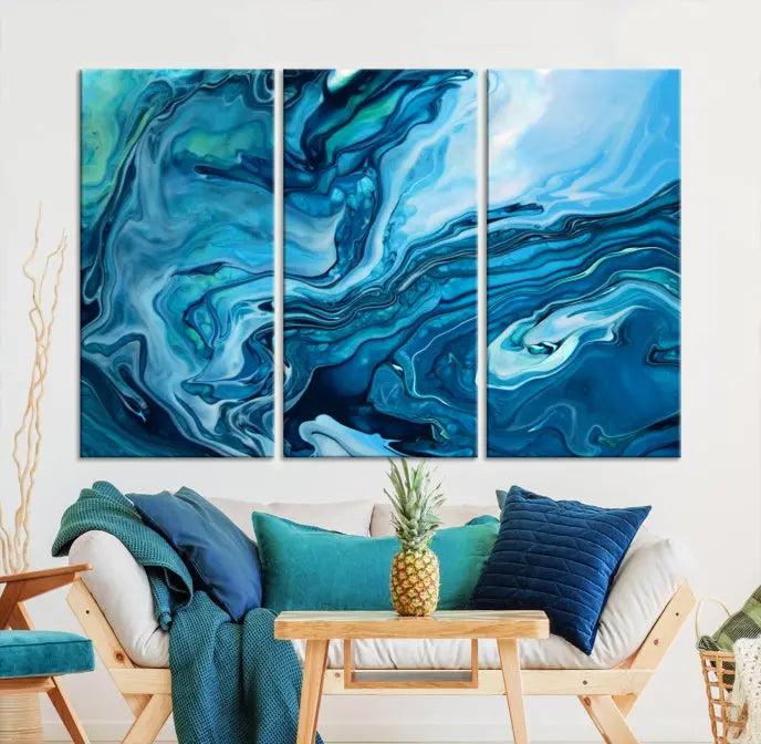 A triptych of the Navy Blue Marble Fluid Effect Wall Art Abstract Canvas Print, featuring swirling blue patterns, graces the space. These pieces are crafted on museum-quality canvas and gallery wrapped with a UV-protective coating to ensure longevity.