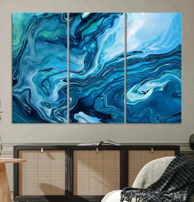 A triptych of the Navy Blue Marble Fluid Effect Wall Art Abstract Canvas Print, featuring swirling blue patterns, graces the space. These pieces are crafted on museum-quality canvas and gallery wrapped with a UV-protective coating to ensure longevity.