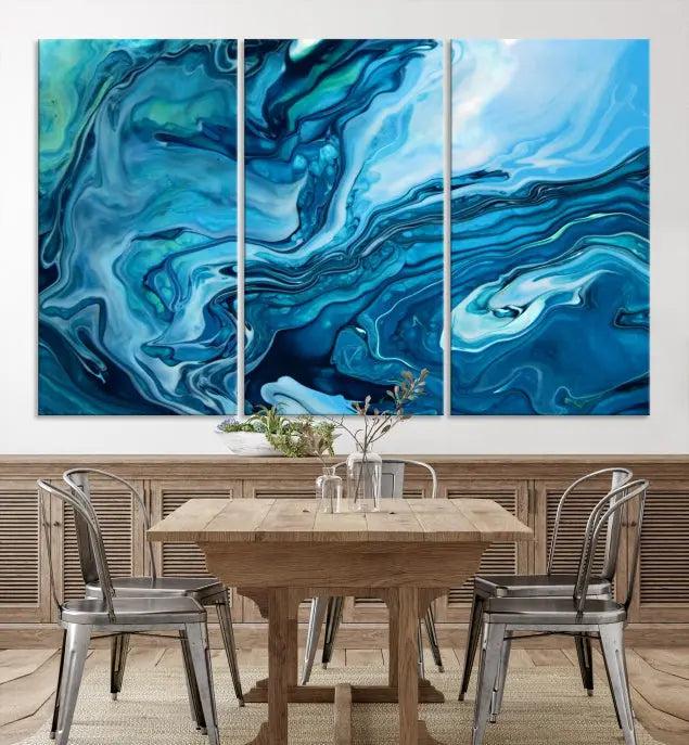 A triptych of the Navy Blue Marble Fluid Effect Wall Art Abstract Canvas Print, featuring swirling blue patterns, graces the space. These pieces are crafted on museum-quality canvas and gallery wrapped with a UV-protective coating to ensure longevity.