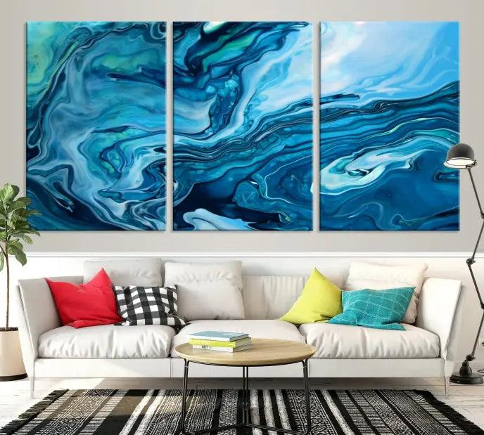 A triptych of the Navy Blue Marble Fluid Effect Wall Art Abstract Canvas Print, featuring swirling blue patterns, graces the space. These pieces are crafted on museum-quality canvas and gallery wrapped with a UV-protective coating to ensure longevity.