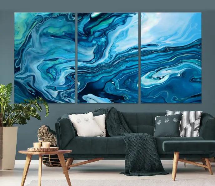 A triptych of the Navy Blue Marble Fluid Effect Wall Art Abstract Canvas Print, featuring swirling blue patterns, graces the space. These pieces are crafted on museum-quality canvas and gallery wrapped with a UV-protective coating to ensure longevity.