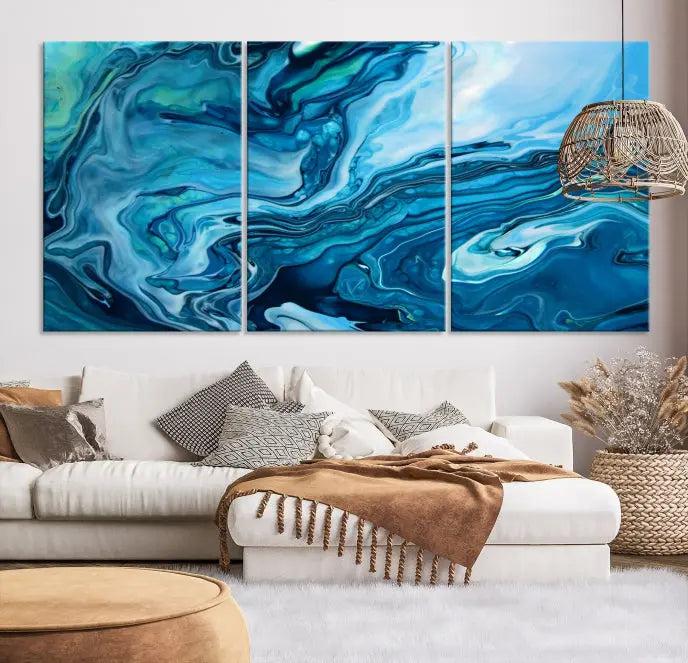 A triptych of the Navy Blue Marble Fluid Effect Wall Art Abstract Canvas Print, featuring swirling blue patterns, graces the space. These pieces are crafted on museum-quality canvas and gallery wrapped with a UV-protective coating to ensure longevity.