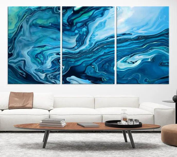 A triptych of the Navy Blue Marble Fluid Effect Wall Art Abstract Canvas Print, featuring swirling blue patterns, graces the space. These pieces are crafted on museum-quality canvas and gallery wrapped with a UV-protective coating to ensure longevity.