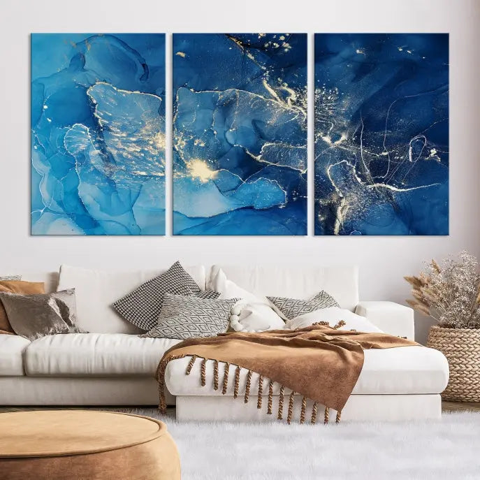 A modern living room features the "Navy Blue Marble Fluid Effect Wall Art Abstract Canvas Wall Art Print" above a white sofa. The museum-quality canvas adds an effortless touch of elegance.