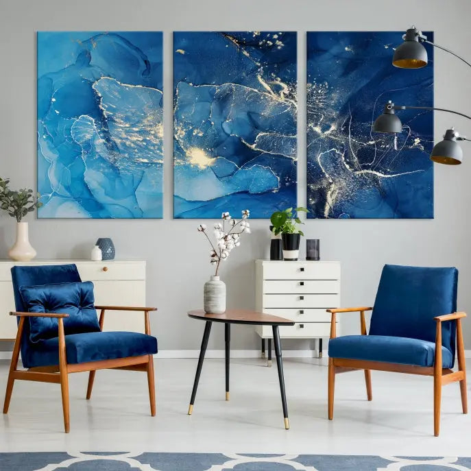 A modern living room features the "Navy Blue Marble Fluid Effect Wall Art Abstract Canvas Wall Art Print" above a white sofa. The museum-quality canvas adds an effortless touch of elegance.