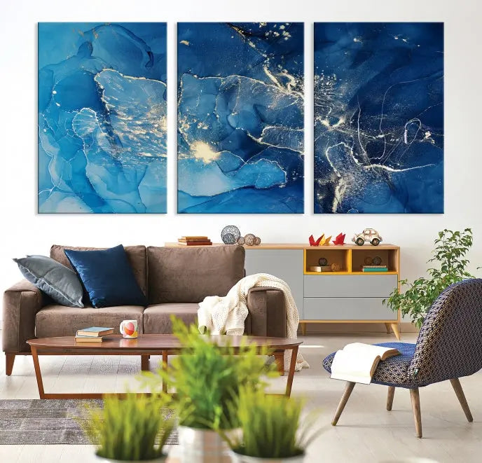 A modern living room features the "Navy Blue Marble Fluid Effect Wall Art Abstract Canvas Wall Art Print" above a white sofa. The museum-quality canvas adds an effortless touch of elegance.