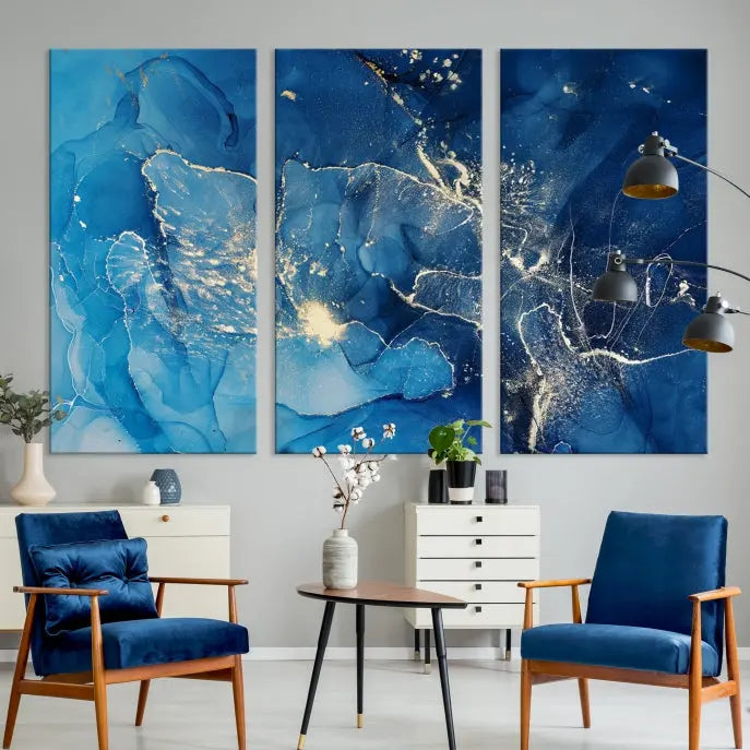 A modern living room features the "Navy Blue Marble Fluid Effect Wall Art Abstract Canvas Wall Art Print" above a white sofa. The museum-quality canvas adds an effortless touch of elegance.