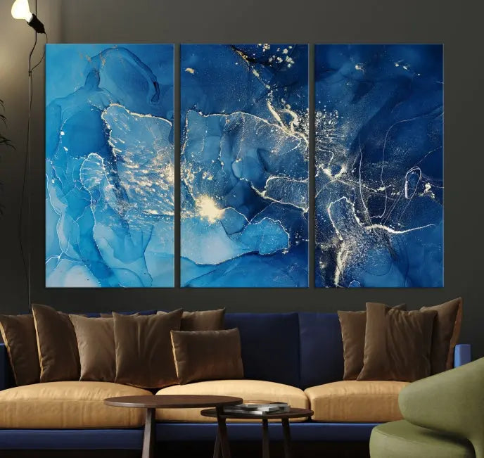 A modern living room features the "Navy Blue Marble Fluid Effect Wall Art Abstract Canvas Wall Art Print" above a white sofa. The museum-quality canvas adds an effortless touch of elegance.