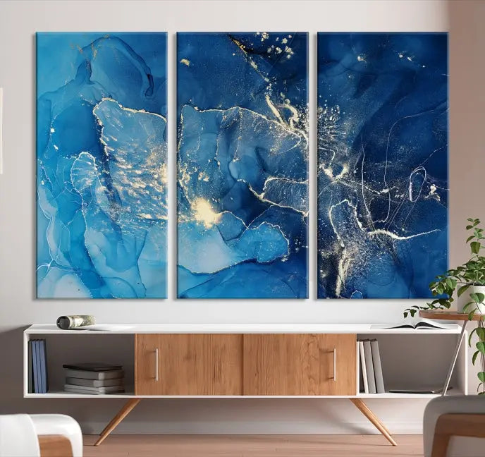 A modern living room features the "Navy Blue Marble Fluid Effect Wall Art Abstract Canvas Wall Art Print" above a white sofa. The museum-quality canvas adds an effortless touch of elegance.