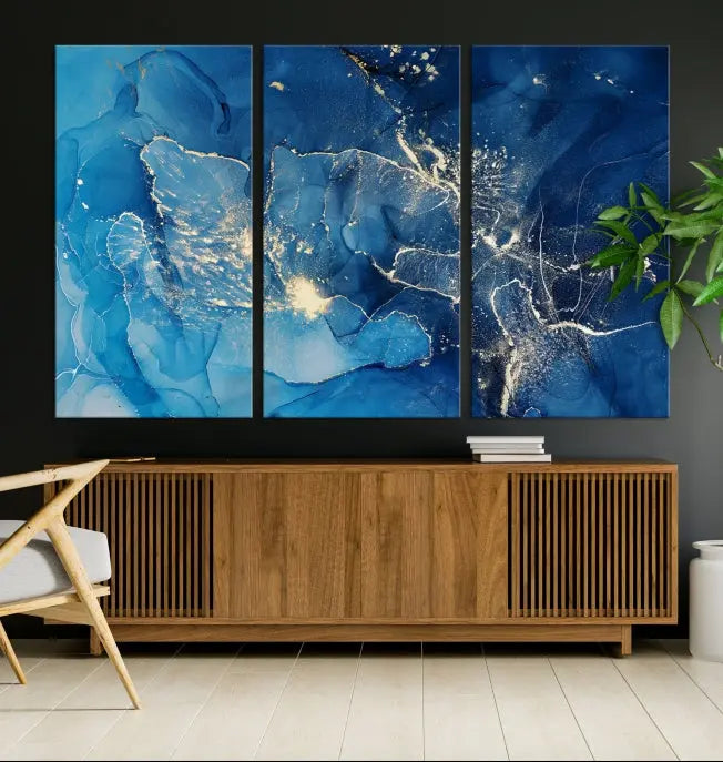 A modern living room features the "Navy Blue Marble Fluid Effect Wall Art Abstract Canvas Wall Art Print" above a white sofa. The museum-quality canvas adds an effortless touch of elegance.