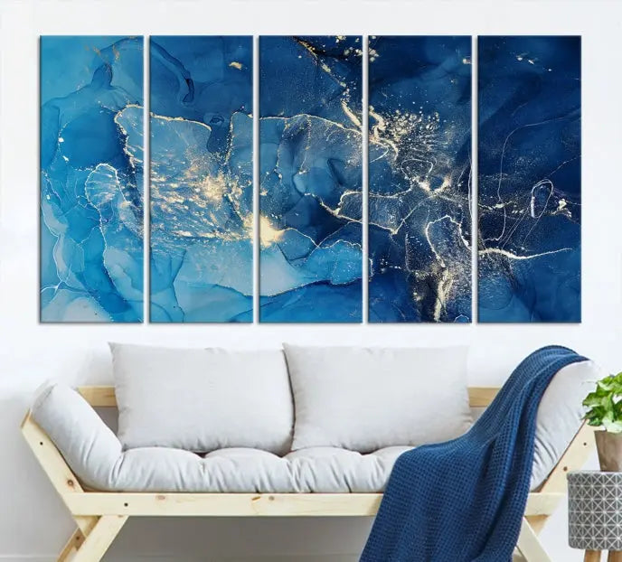 A modern living room features the "Navy Blue Marble Fluid Effect Wall Art Abstract Canvas Wall Art Print" above a white sofa. The museum-quality canvas adds an effortless touch of elegance.