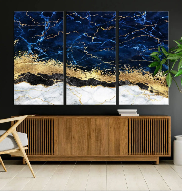 The living room is adorned with the Navy Blue Marble Fluid Effect Wall Art Abstract Canvas Wall Art Print. This ready-to-hang three-panel artwork features blue, gold, and white tones on museum-quality canvas with a UV-protective coating.