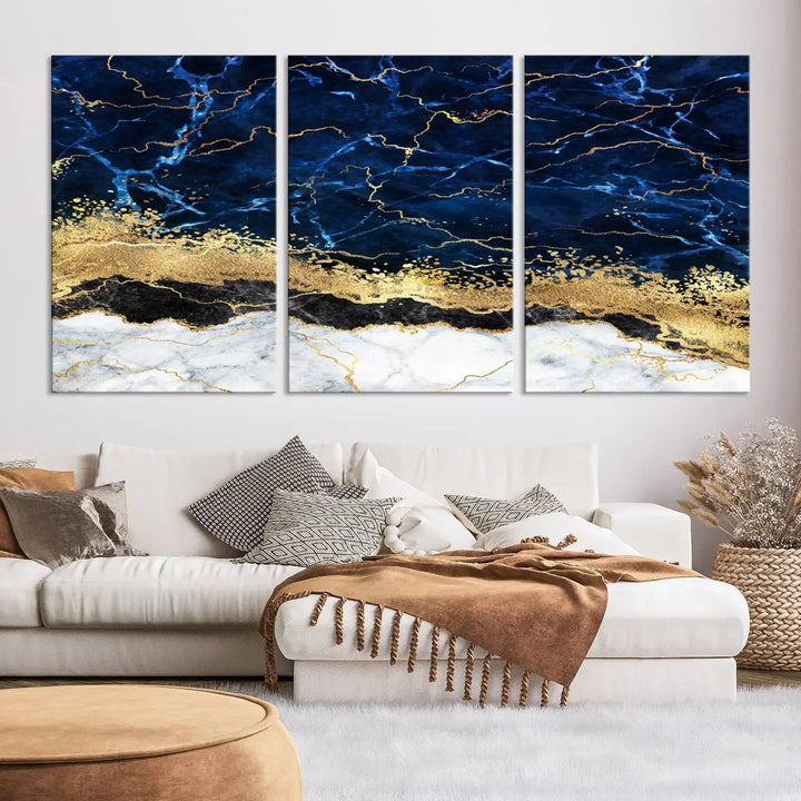 The living room is adorned with the Navy Blue Marble Fluid Effect Wall Art Abstract Canvas Wall Art Print. This ready-to-hang three-panel artwork features blue, gold, and white tones on museum-quality canvas with a UV-protective coating.